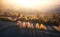 Aerial view of orange forest in low clouds at sunrise in autumn