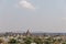 Aerial view of Orchha Fort in India in the distance, sunlit with a clear blue sky