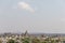 Aerial view of Orchha Fort in India in the distance, sunlit with a clear blue sky
