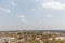 Aerial view of Orchha Fort in India in the distance, sunlit with a clear blue sky