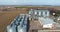 aerial view over agro-industrial complex with silos and grain drying line