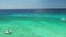 Aerial view over Caribbean sea water. Catamaran and speed boats in the ocean.