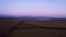 Aerial view over farming fields at twilight