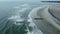Aerial view over gentle surf, flying over the breaking waves along the Atlantic coast
