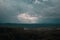 Aerial view over the green forest in evening. Cloudy mystery. Landscapes of Latvia.