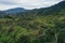 Aerial view over a green valley with a road meandering through the meadows in the Andes of Ecuador