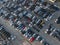 Aerial view over huge outdoor parking lots with many cars and vehicles