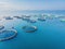 Aerial view over large fish farm with lots of fish enclosures