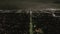 AERIAL: View over Los Angeles at Night with Wilshire Boulevard Glowing Streets and City Car Traffic Lights