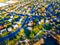 Aerial View Over Modern Suburb Home Community with Fall Colors