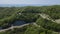 Aerial view over mountain road going through forest landscape, Winding road from high mountain pass.