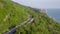 Aerial view over mountain road going through forest landscape, Winding road from high mountain pass.