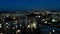 Aerial view over Multi-Storey Building with changing Window Lighting at Night. Time Lapse