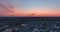 Aerial view over the private town residential gardens a orange dramatic sky during sunset over beautiful natural