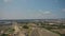 Aerial view over the rural landscape village trees fields classic blue sky