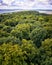 Aerial view over the trees in the forest with a view of the Baltic Sea on the horizon. RÃ¼gen