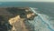 Aerial view, Pacific waves wash over the rugged coast of northern California. The Pacific Coast Scenic Highway runs