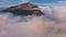 Aerial view panorama of misty Carpathian mountains at autumn sunrise above foggy clouds nature