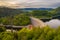 Aerial view on panorama of stone dam at reservoir with flowing water, hydroelectricity power station in Pilchowice