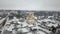 Aerial view of the panorama of the Ukrainian city with a church, in winter during a snowfall