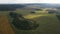 Aerial view of panoramic landscape, drone flies forwards over the agricultural fields