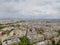 Aerial view of the Paris cityscape, with buildings going to a cloudy horizon