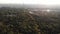 Aerial view of Paris skyline with Eiffel Tower from the side of Boulogne Forest with a curvy forest road at rising