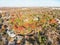 Aerial view park side suburban house with dense autumn leaves South of Dallas