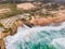 Aerial view of a parking lot and an endless road along the wild coastline in southern Portugal, view of Guincho beach and the