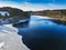 Aerial view of the partially frozen Lingese dam near Marienheide in winter.