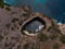 Aerial view of Pasih Uug Broken beach eye tropical rock arch tunnel cliff cove natural bridge Nusa Penida Bali Indonesia