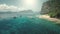 Aerial view of passenger boats with tourists rest at ocean sand coast of Palawan harbor, Philippines, Asia