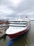 Aerial view of a passenger ship in alongside the terminal of port. Nose of the cruise ship near the pier. Aerial photography