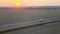 Aerial view of passenger van driving fast on intercity road at sunset. Highway traffic in evening