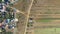 Aerial view of paved road intersecting with dirt road