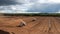 Aerial view of a peat extraction field with harvesting machinery in Viljandi County, Estonia