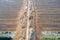 Aerial view of peat harvesting field. Peat extraction. Piles of peat