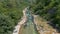 Aerial View of People in Boat Engaging in Rafting Adventure on a Clear River