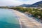 Aerial view of people swimming in the transparent turquoise sea at Karon beach in Phuket, Thailand