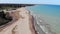 Aerial view people walking dogs on the shores of Lake Michigan in Illinois. People walking dogs on a sandy beach.