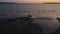 Aerial view of person riding a horse on a beach at sunset