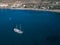 Aerial view photo of Luxury vintage two masted tourist trip ship stays on anchor in the bay, calm transparent water of