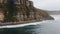 Aerial view of the picturesque high coastline, sharp cliffs and raging sea