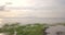 Aerial view of a pink colored sunset over the calm water of the St-Lawrence River in La Pocatiere, Quebec