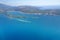 Aerial view from the plane of the mountains of Montenegro, the coast, the city and the Adriatic. 