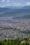 Aerial view of Pokhara city in Nepal with dense houses on the mountain hills.