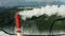 Aerial view of a polluting industrial smokestack on forest background in winter