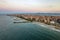 Aerial view of Pomorie city that is located on Black Sea shore. Top view of sand beaches with many hotel buildings and tourist