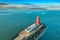 Aerial view of Poolbeg Lighthouse the famous red landmark in Dublin Harbor Ireland seen by drone at sunset