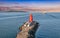 Aerial view of Poolbeg Lighthouse the famous red landmark in Dublin Harbor Ireland seen by drone at sunset